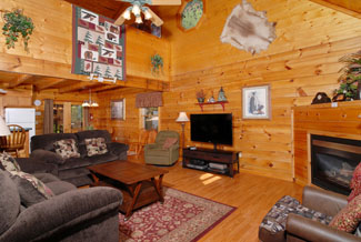 Living Room Area that has cathedral ceilings that look up to the lofted game room